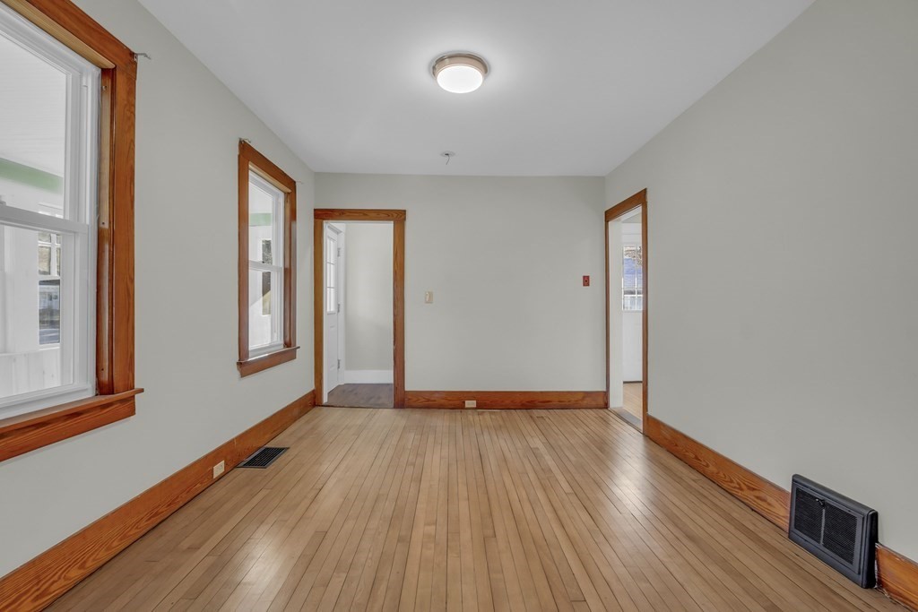 233 Petersham Road Athol, MA 01331 - Photo 13 of 31 a view of an empty room with wooden floor and a window