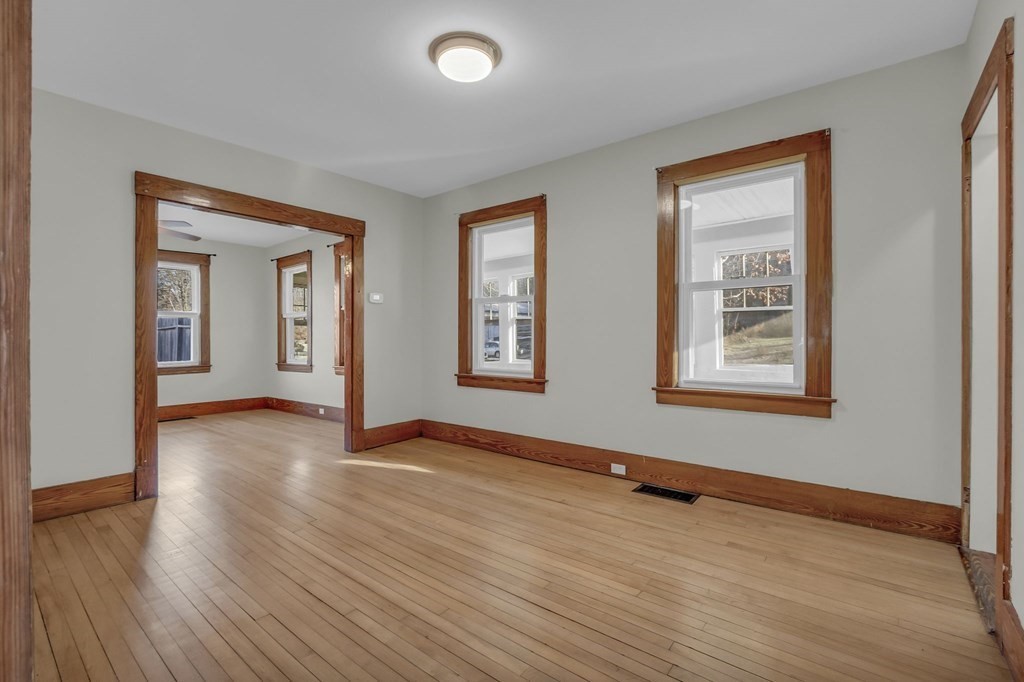 233 Petersham Road Athol, MA 01331 - Photo 18 of 31 a view of an empty room with wooden floor and a window