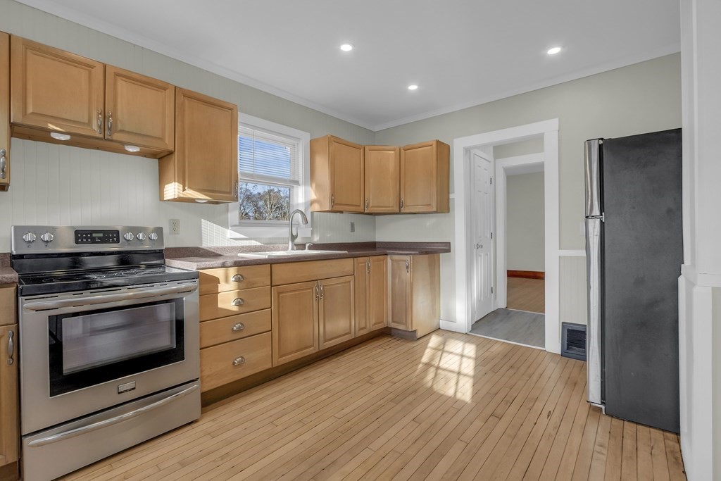 233 Petersham Road Athol, MA 01331 - Photo 6 of 31 a kitchen with stainless steel appliances granite countertop a stove a sink and a refrigerator
