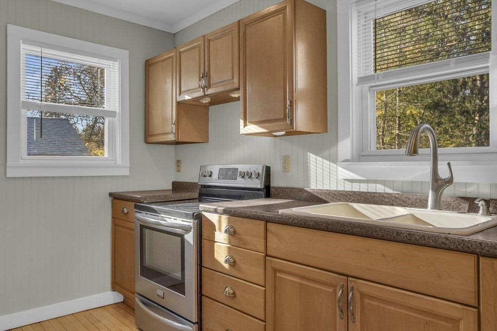 233 Petersham Road Athol, MA 01331 - Photo 7 of 31 a kitchen with stainless steel appliances granite countertop a sink a stove and a microwave