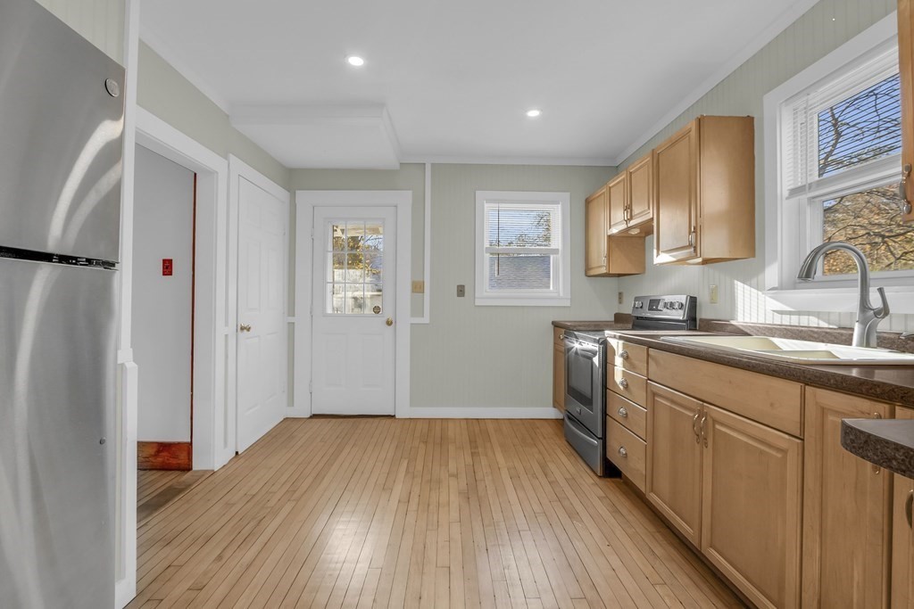 233 Petersham Road Athol, MA 01331 - Photo 9 of 31 a kitchen with wooden floors and white cabinets