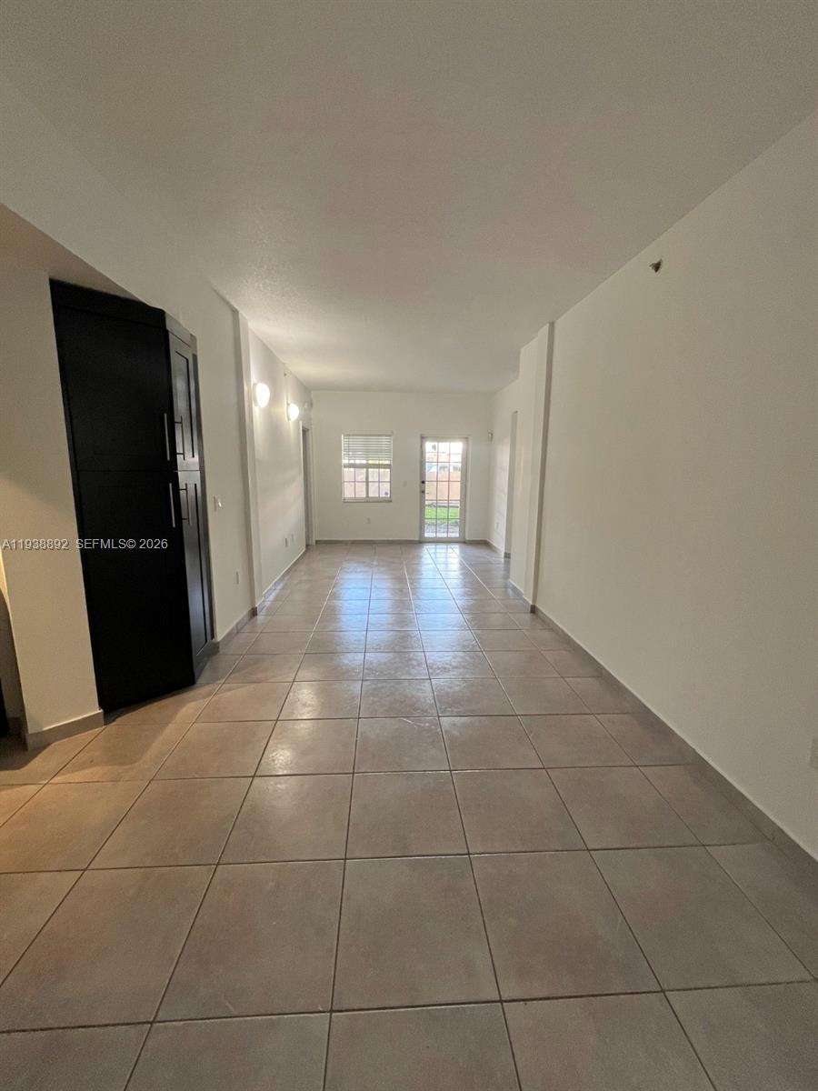17455 Northwest 75th Place, Unit 104 Hialeah, FL 33015 - Photo 3 of 7 a view of a hallway to the room