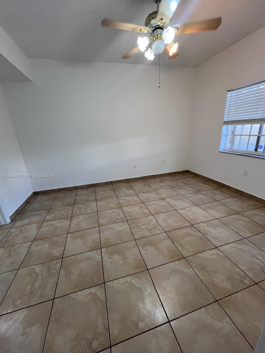 17455 Northwest 75th Place, Unit 104 Hialeah, FL 33015 - Photo 6 of 7 a view of an empty room with a window