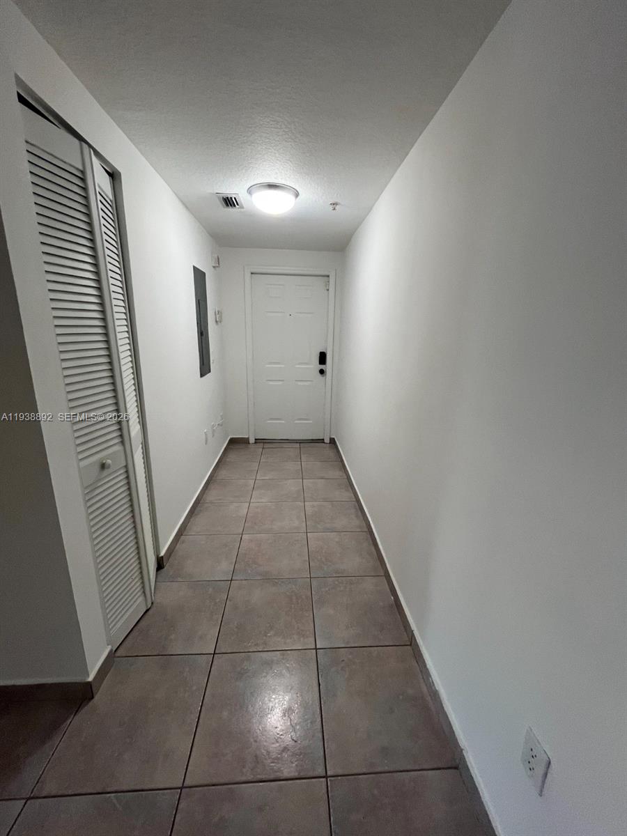 17455 Northwest 75th Place, Unit 104 Hialeah, FL 33015 - Photo 7 of 7 a view of hallway with a window