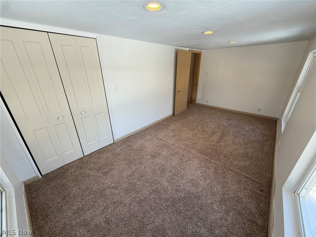 6784 Old Zoarville Road Northeast Dover, OH 44622 - Photo 29 of 50 Unfurnished bedroom featuring carpet, a closet, and recessed lighting