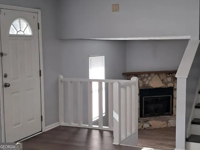 a view of a hallway with a room and stairs
