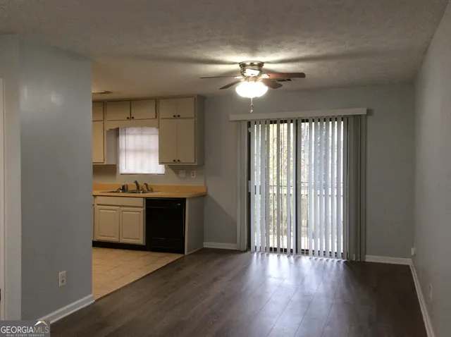a kitchen with a sink window and cabinets