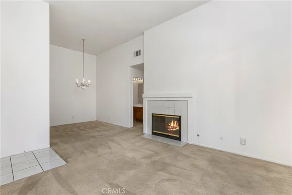 a view of an empty room with a fireplace