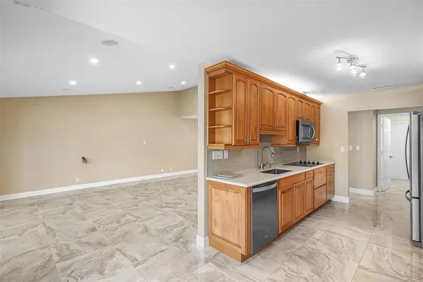 a kitchen with stainless steel appliances granite countertop a stove and a sink