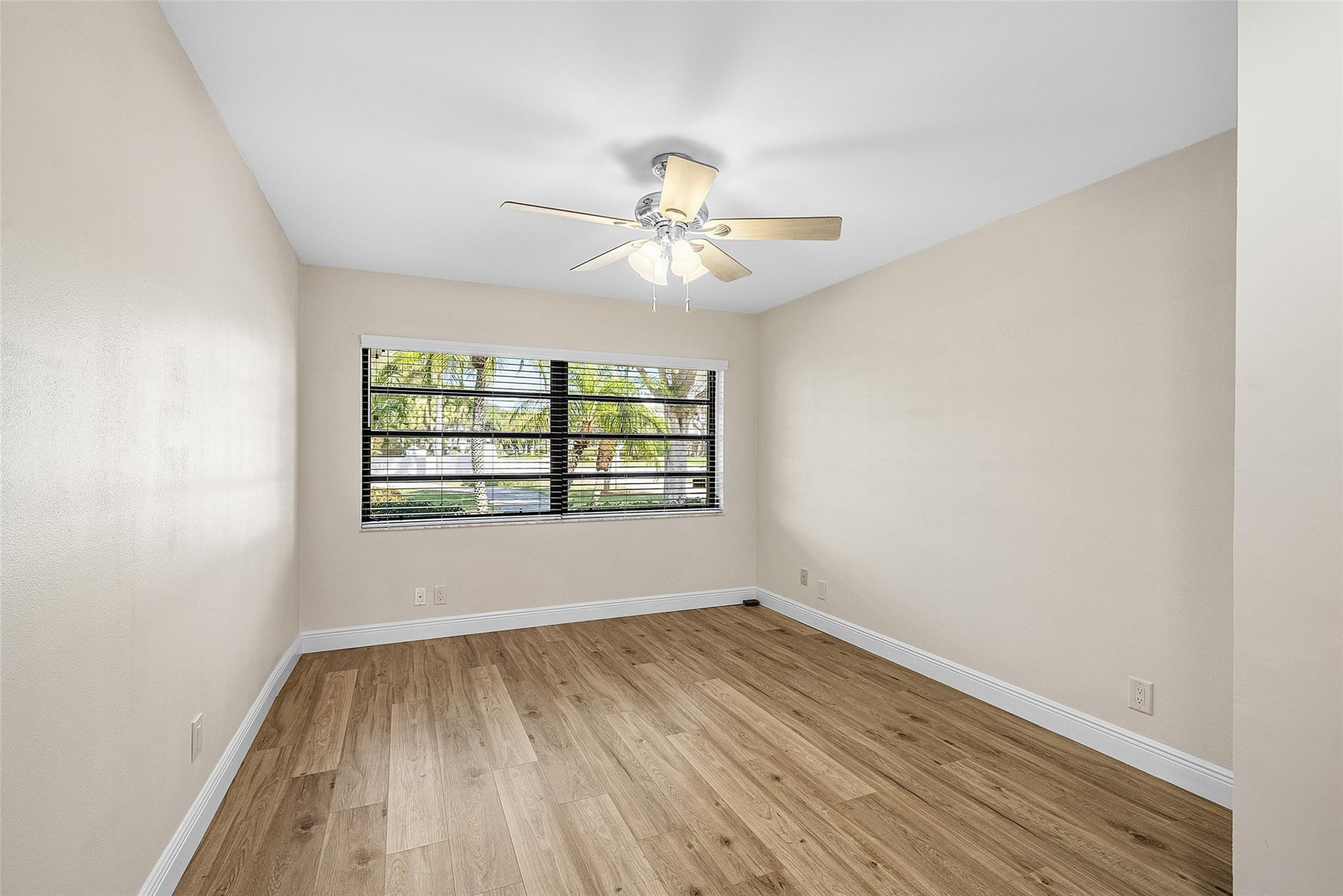 6191 Petaluma Drive Boca Raton, FL 33433 - Photo 21 of 36 an empty room with wooden floor and windows