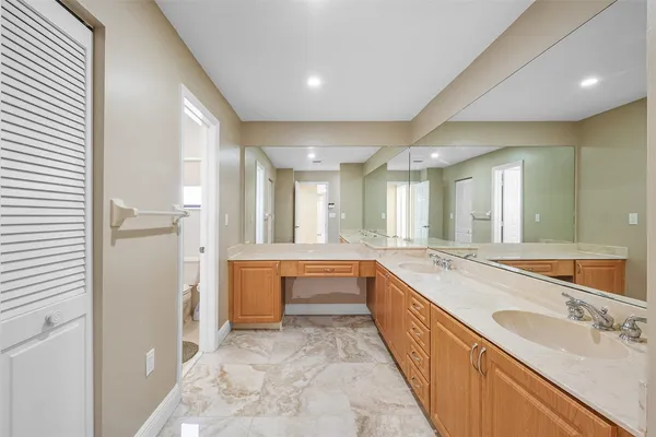 a large bathroom with a large tub sink and double vanity
