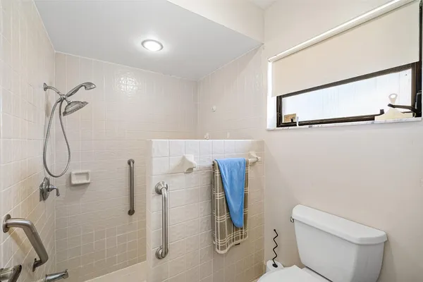 a bathroom with a toilet and a shower