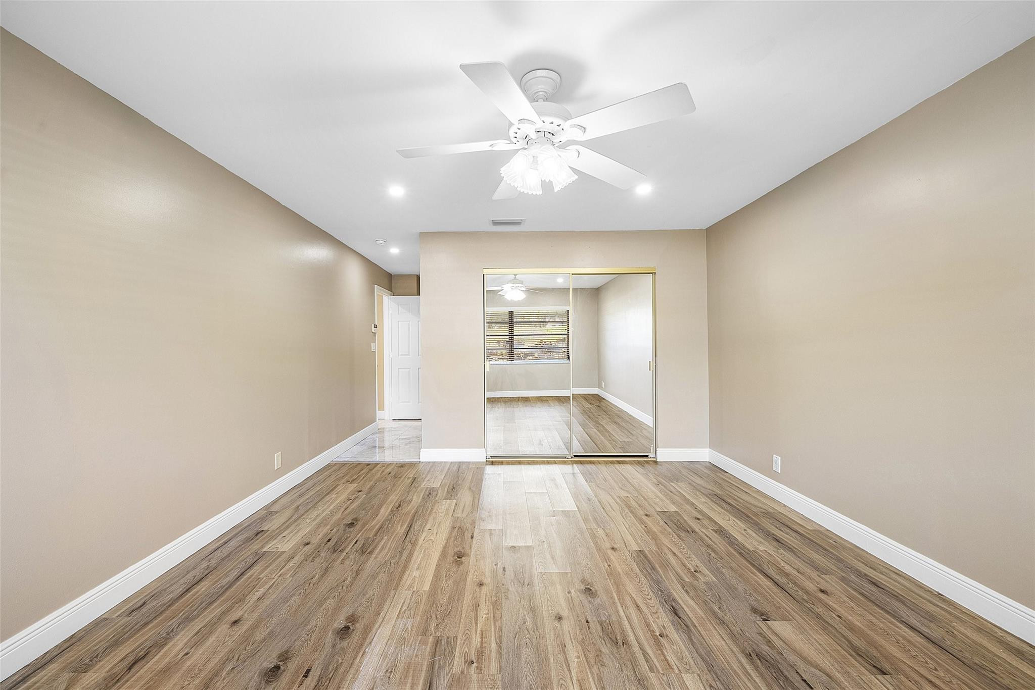 6191 Petaluma Drive Boca Raton, FL 33433 - Photo 27 of 36 a view of an empty room with wooden floor and a window