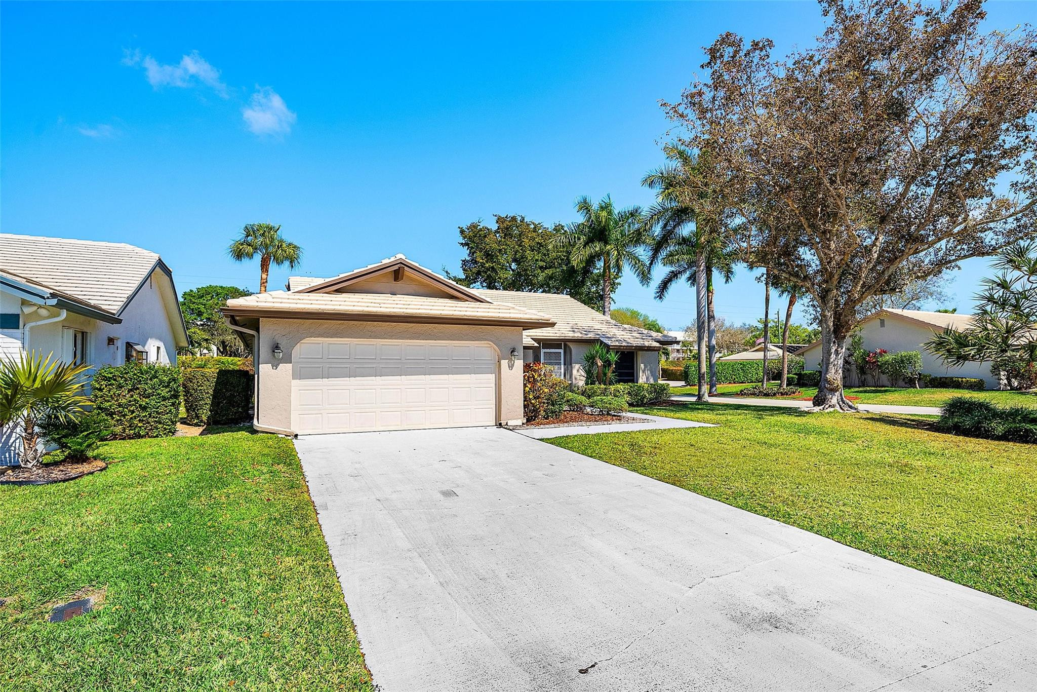 6191 Petaluma Drive Boca Raton, FL 33433 - Photo 3 of 36 a front view of a house with a yard and garage