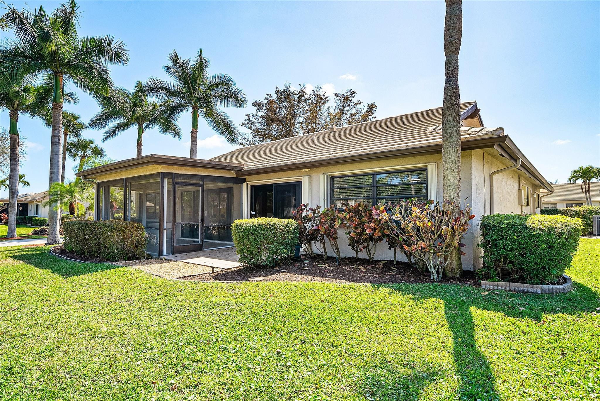 6191 Petaluma Drive Boca Raton, FL 33433 - Photo 31 of 36 a front view of a house with a yard and potted plants