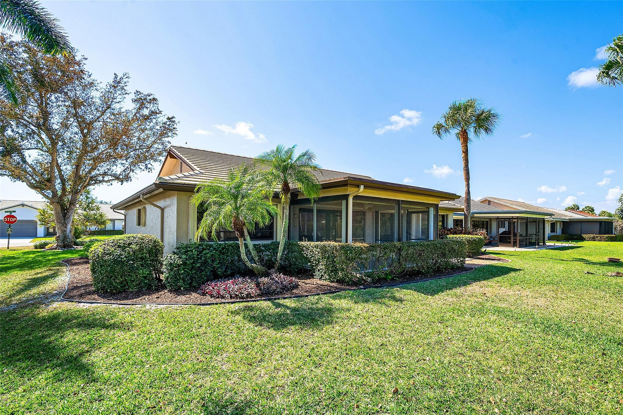 6191 Petaluma Drive Boca Raton, FL 33433 - Photo 32 of 36 a front view of a house with a yard and potted plants