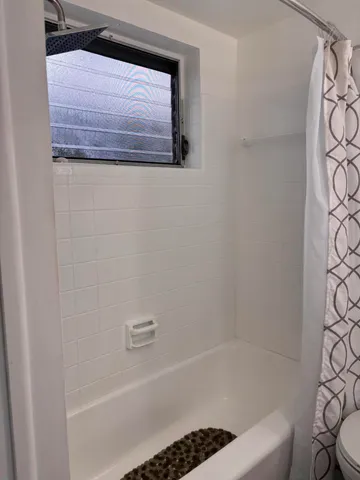 a bathroom with a bathtub and shower