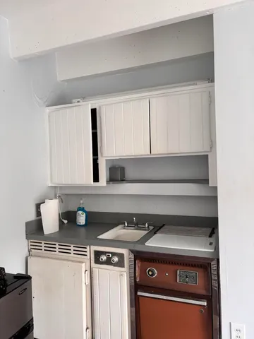 a stove top oven sitting inside of a kitchen