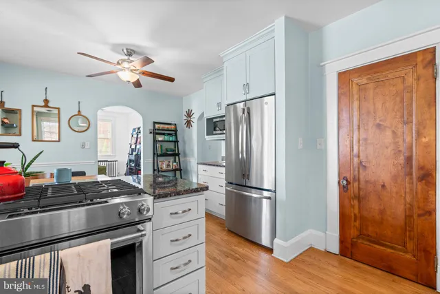 a kitchen with stainless steel appliances a refrigerator and a stove