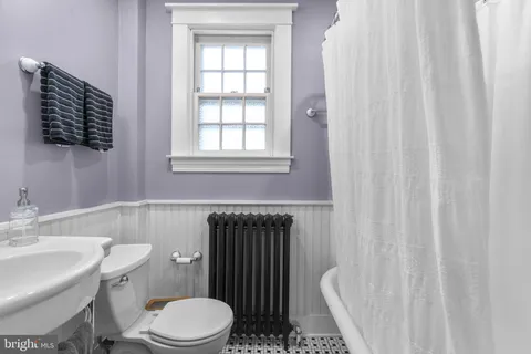 a white toilet sitting next to a bathroom sink