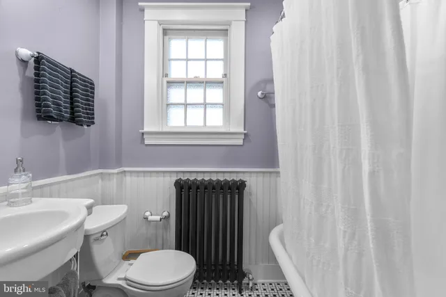 a white toilet sitting next to a bathroom sink