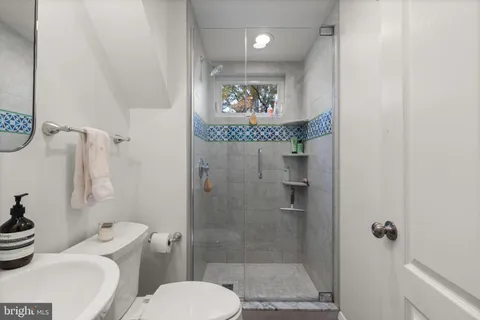 a bathroom with a toilet and a shower