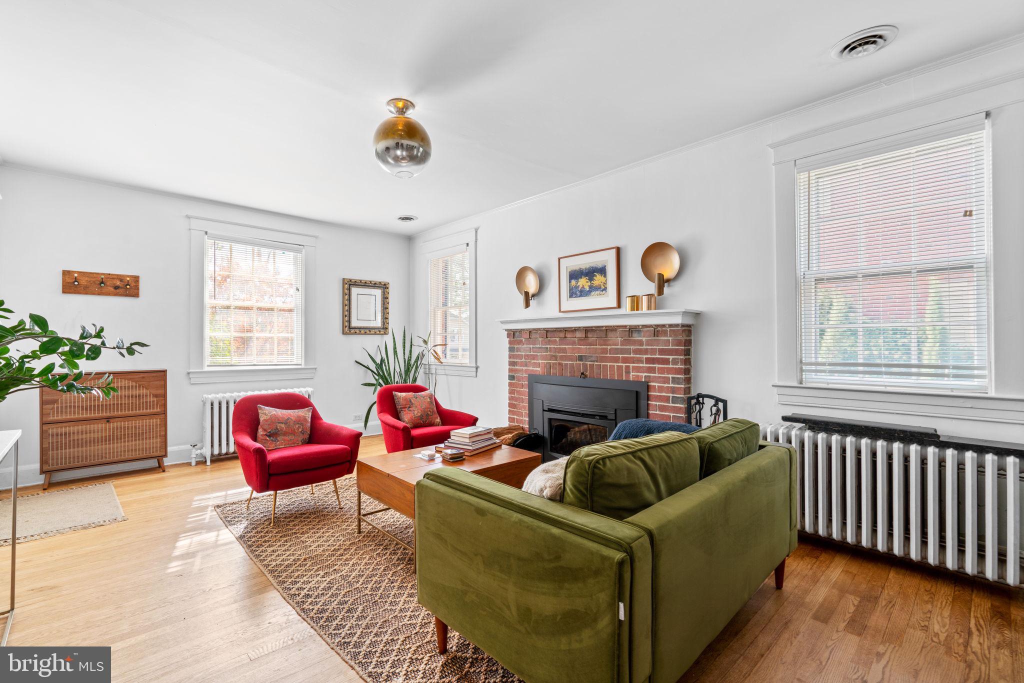 664 Regester Avenue Baltimore, MD 21212 - Photo 3 of 42 a living room with furniture a flat screen tv and a fireplace