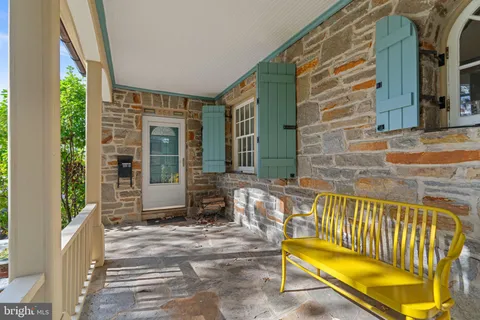 a view of porch with a bench