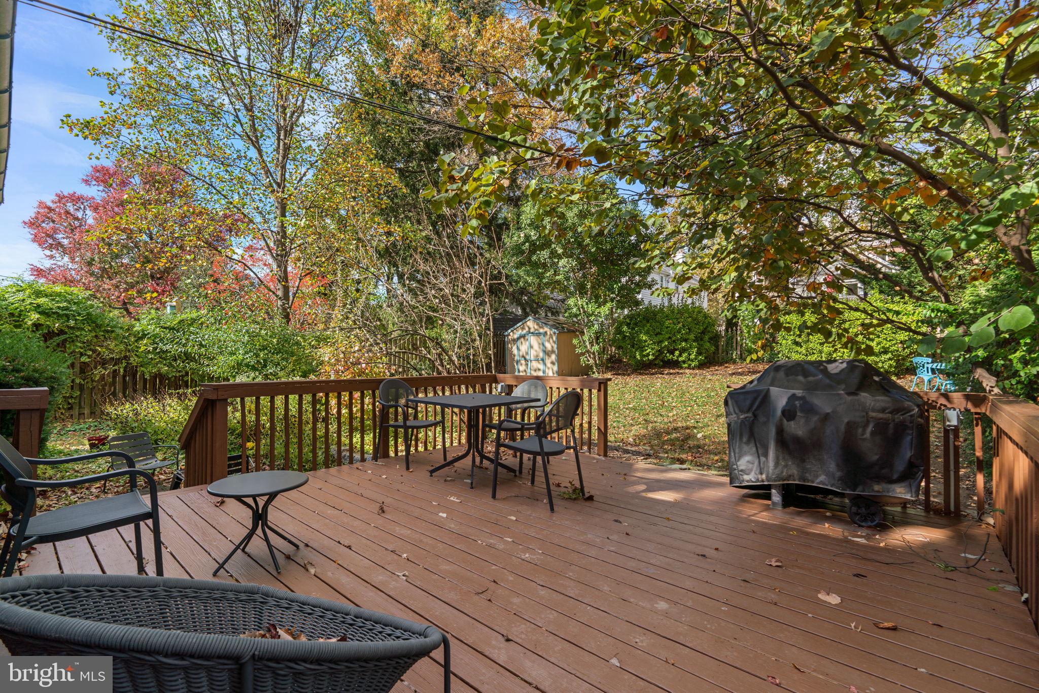 664 Regester Avenue Baltimore, MD 21212 - Photo 36 of 42 a view of a roof deck with table and chairs a barbeque with wooden floor and fence