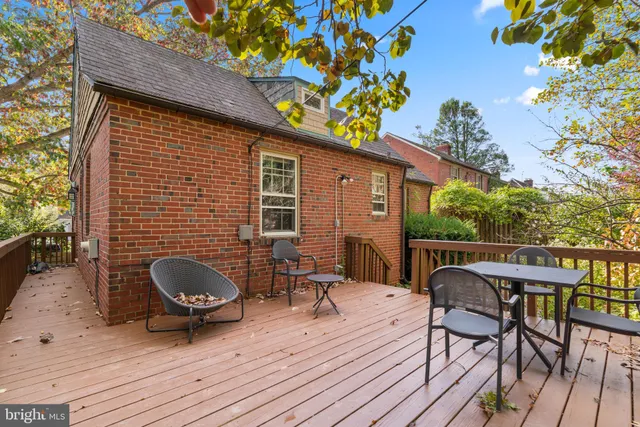 a backyard of a house with wooden floor yard and outdoor seating