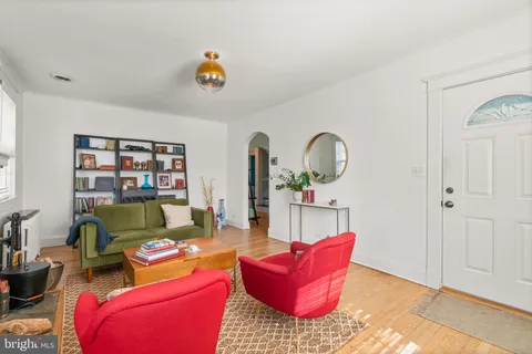 a living room with furniture rug and window