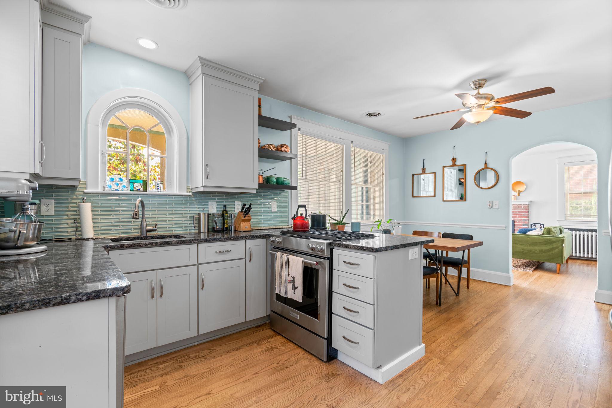 664 Regester Avenue Baltimore, MD 21212 - Photo 6 of 42 a kitchen with a stove a sink a dining table and chairs