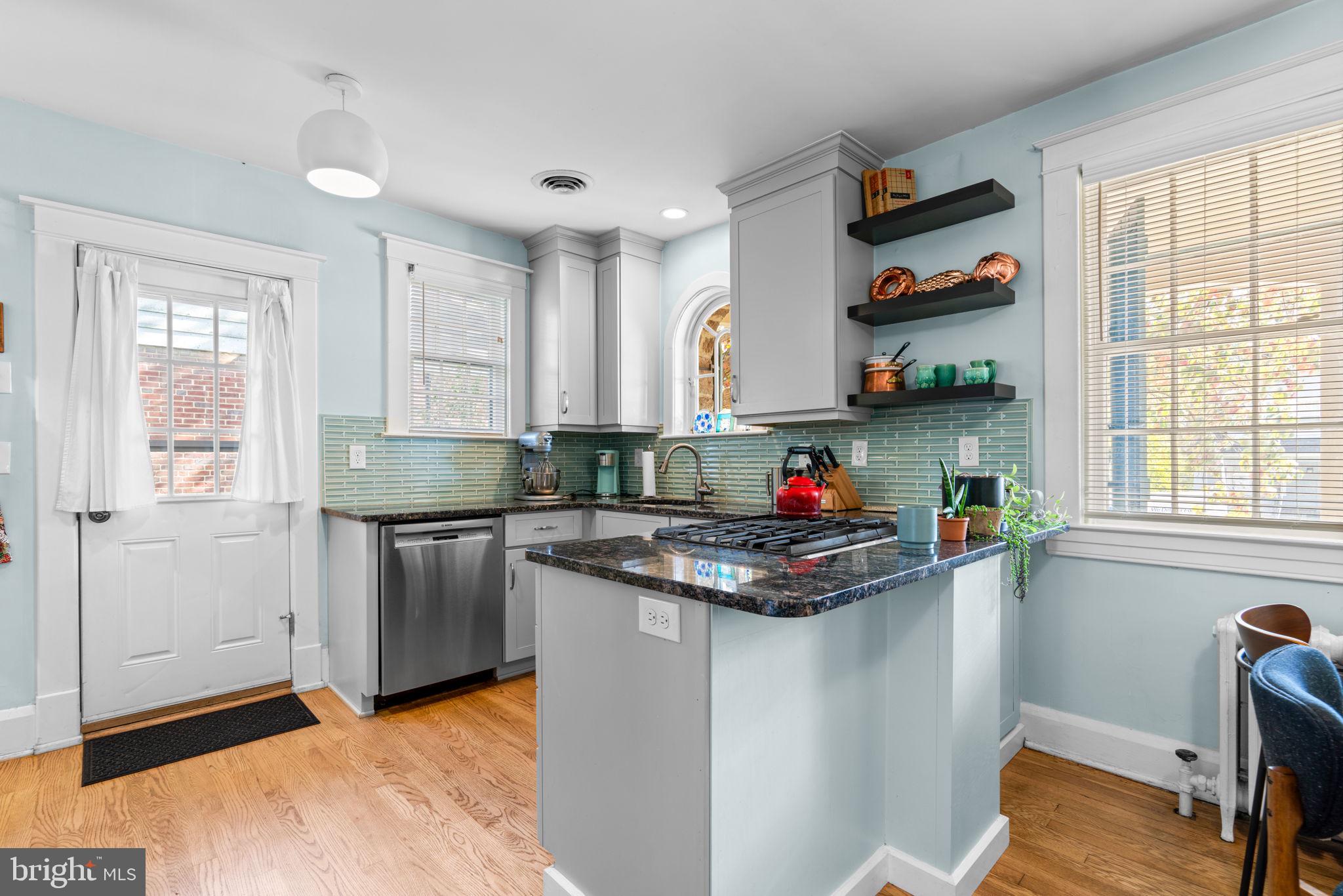 664 Regester Avenue Baltimore, MD 21212 - Photo 9 of 42 a kitchen with stainless steel appliances granite countertop a stove and a sink