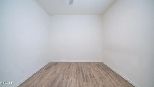 a view of a room with wooden floor