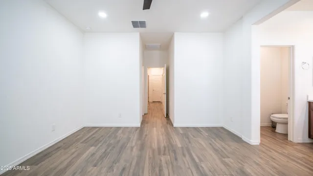 a view of a room with wooden floor and a toilet