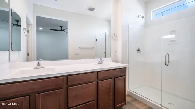 a bathroom with a shower sink vanity and mirror