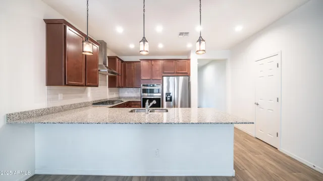 a large kitchen with kitchen island a large counter space a sink appliances and cabinets