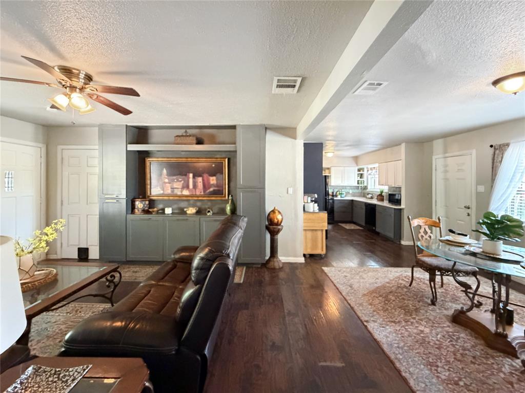 2243 Inca Drive Dallas, TX 75216 - Photo 11 of 24 The living room leads to the additional bedrooms.