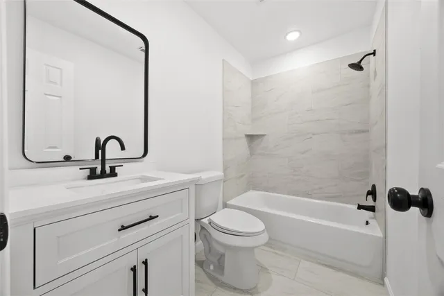 a bathroom with a sink a toilet and a bathtub