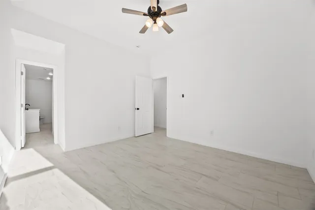 a view of a livingroom with a ceiling fan and window
