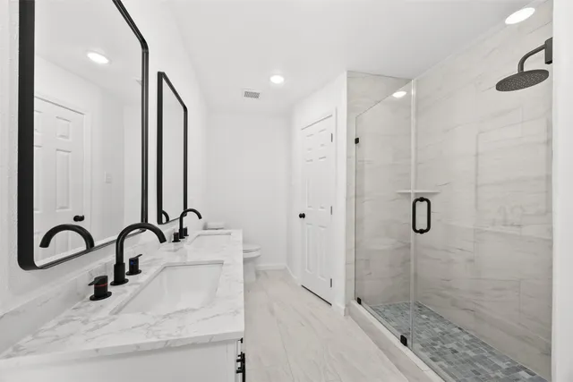 a bathroom with a shower sink and mirror