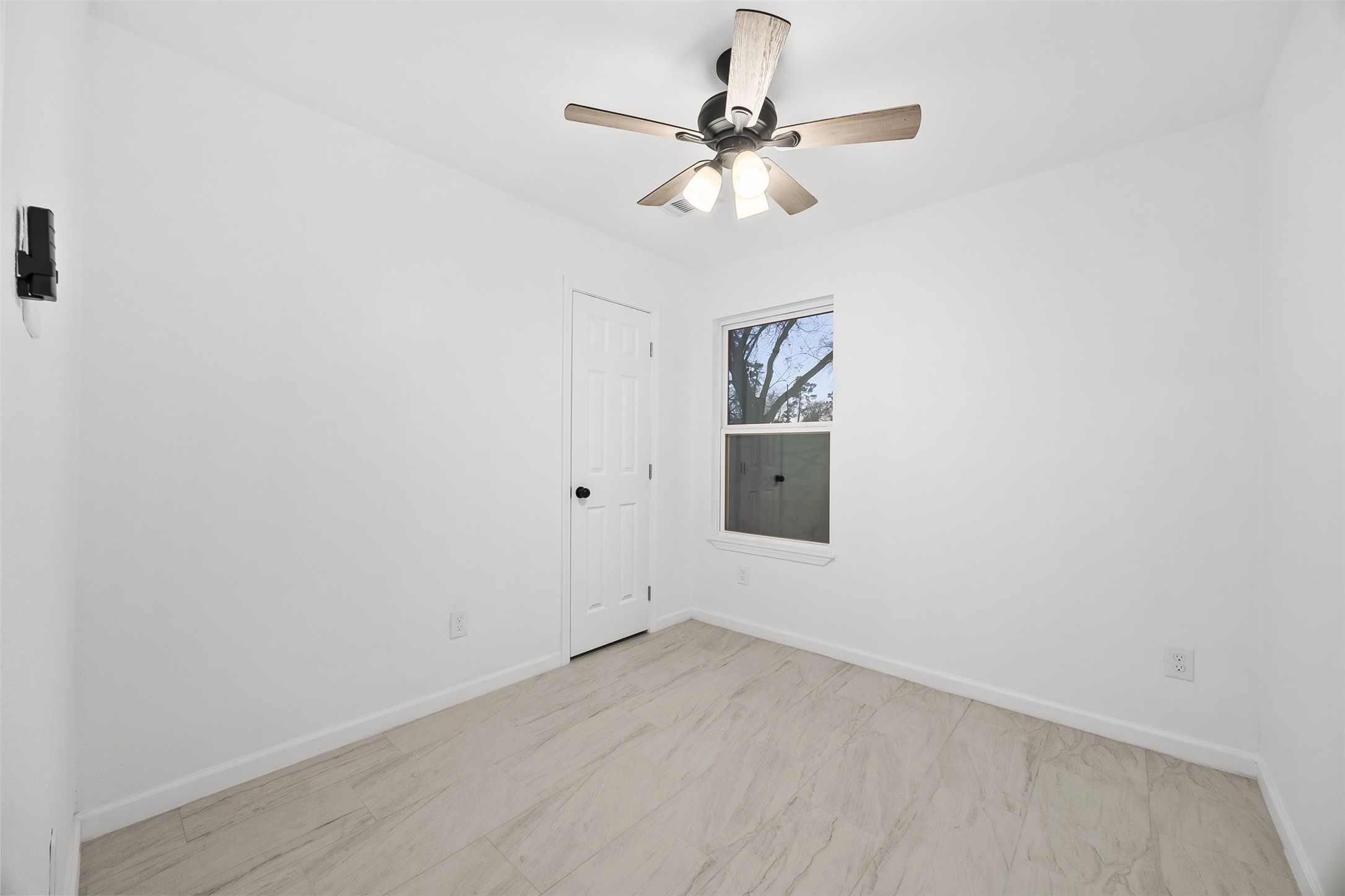 22101 Diane Drive Spring, TX 77373 - Photo 20 of 24 an empty room with a chandelier fan and windows
