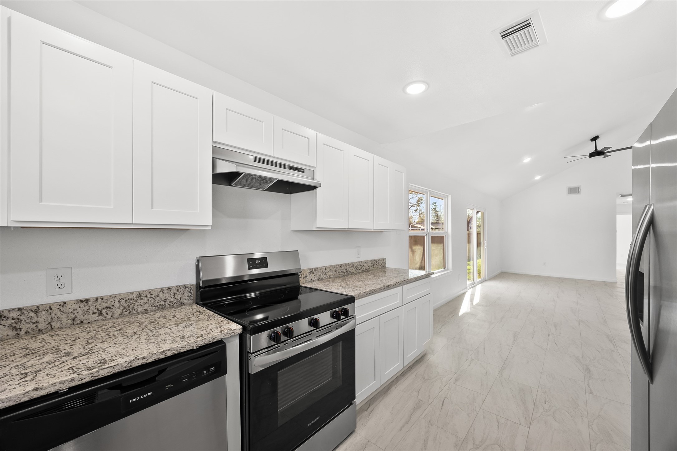 22101 Diane Drive Spring, TX 77373 - Photo 7 of 24 a kitchen with stainless steel appliances granite countertop a stove a refrigerator and a white cabinets