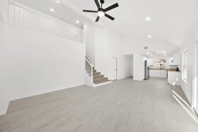 a view of a kitchen with a sink and a refrigerator