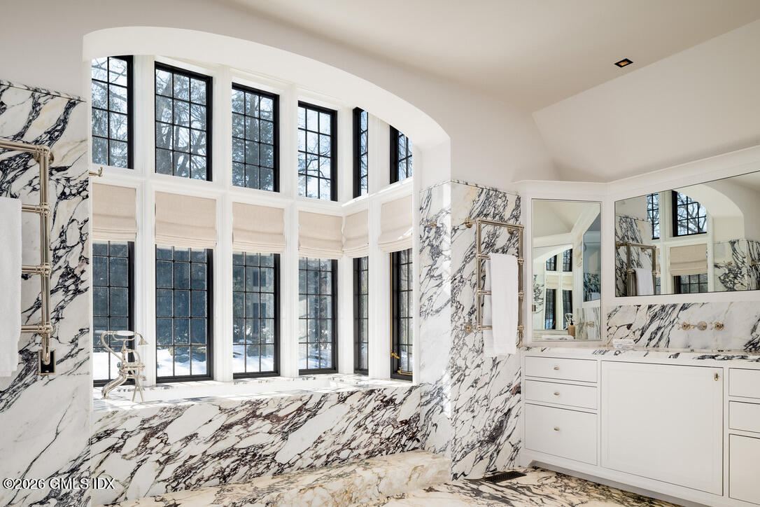 44 Khakum Wood Road Greenwich, CT 06831 - Photo 18 of 31 a large bedroom with a large bed and a large window