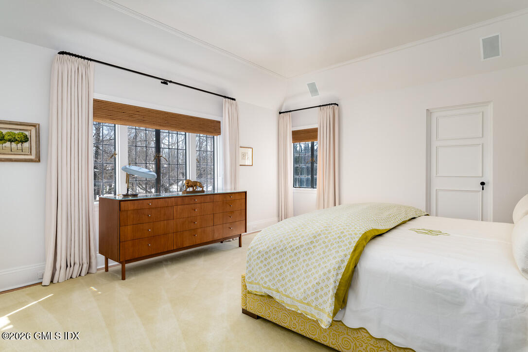 44 Khakum Wood Road Greenwich, CT 06831 - Photo 23 of 31 a bedroom with a bed and a large window