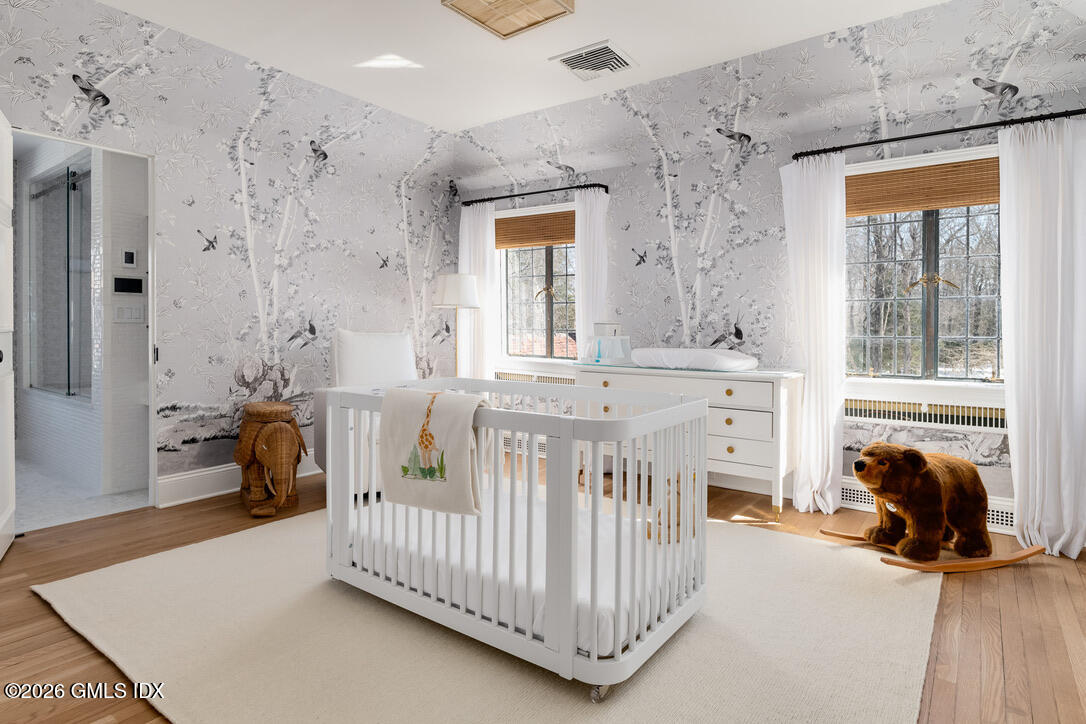 44 Khakum Wood Road Greenwich, CT 06831 - Photo 25 of 31 a bedroom with furniture and a large window