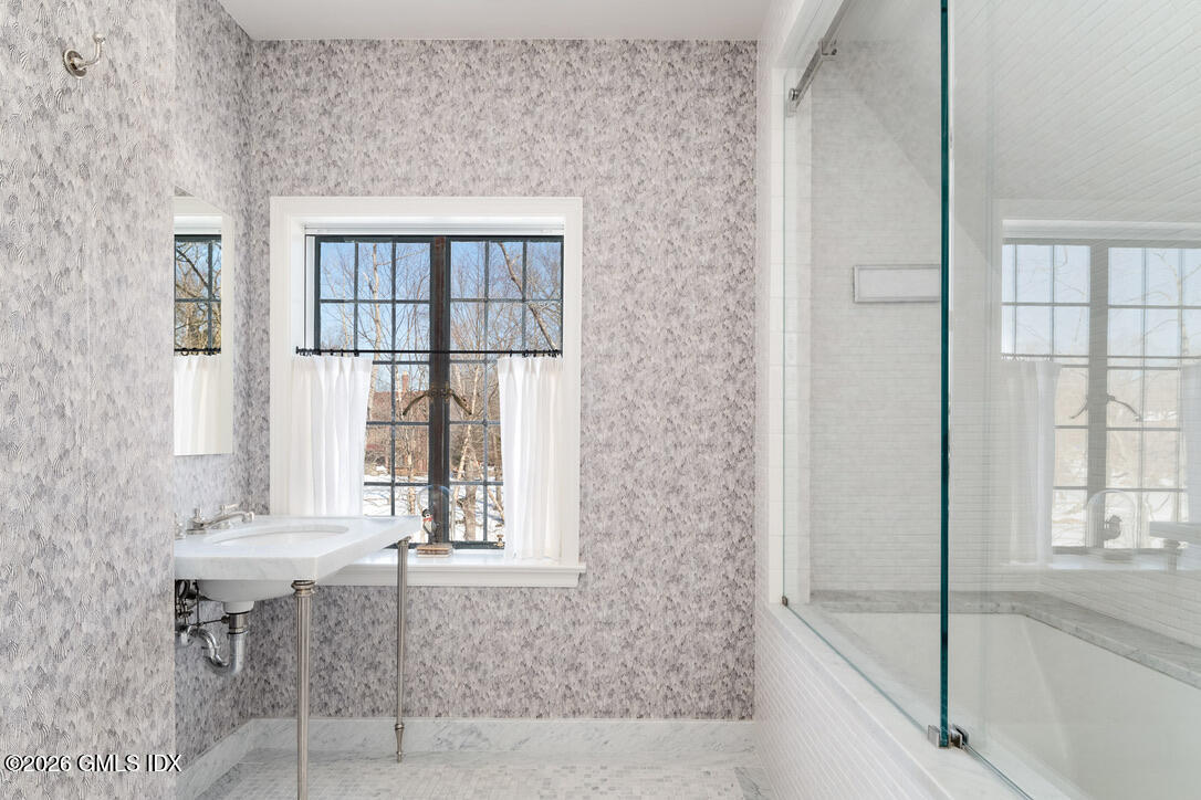 44 Khakum Wood Road Greenwich, CT 06831 - Photo 26 of 31 a bathroom with a window and a bath tub