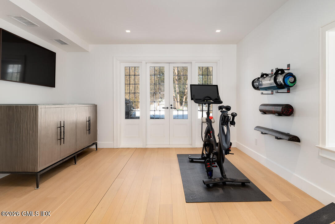44 Khakum Wood Road Greenwich, CT 06831 - Photo 28 of 31 a view of a room with gym equipment and windows