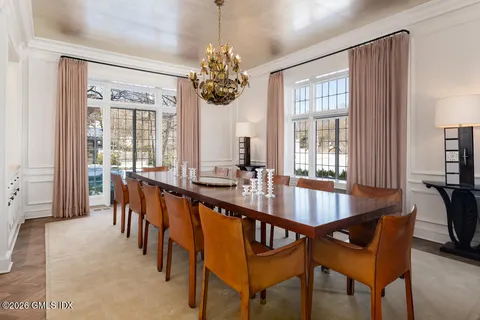 a dining room with furniture a chandelier and window